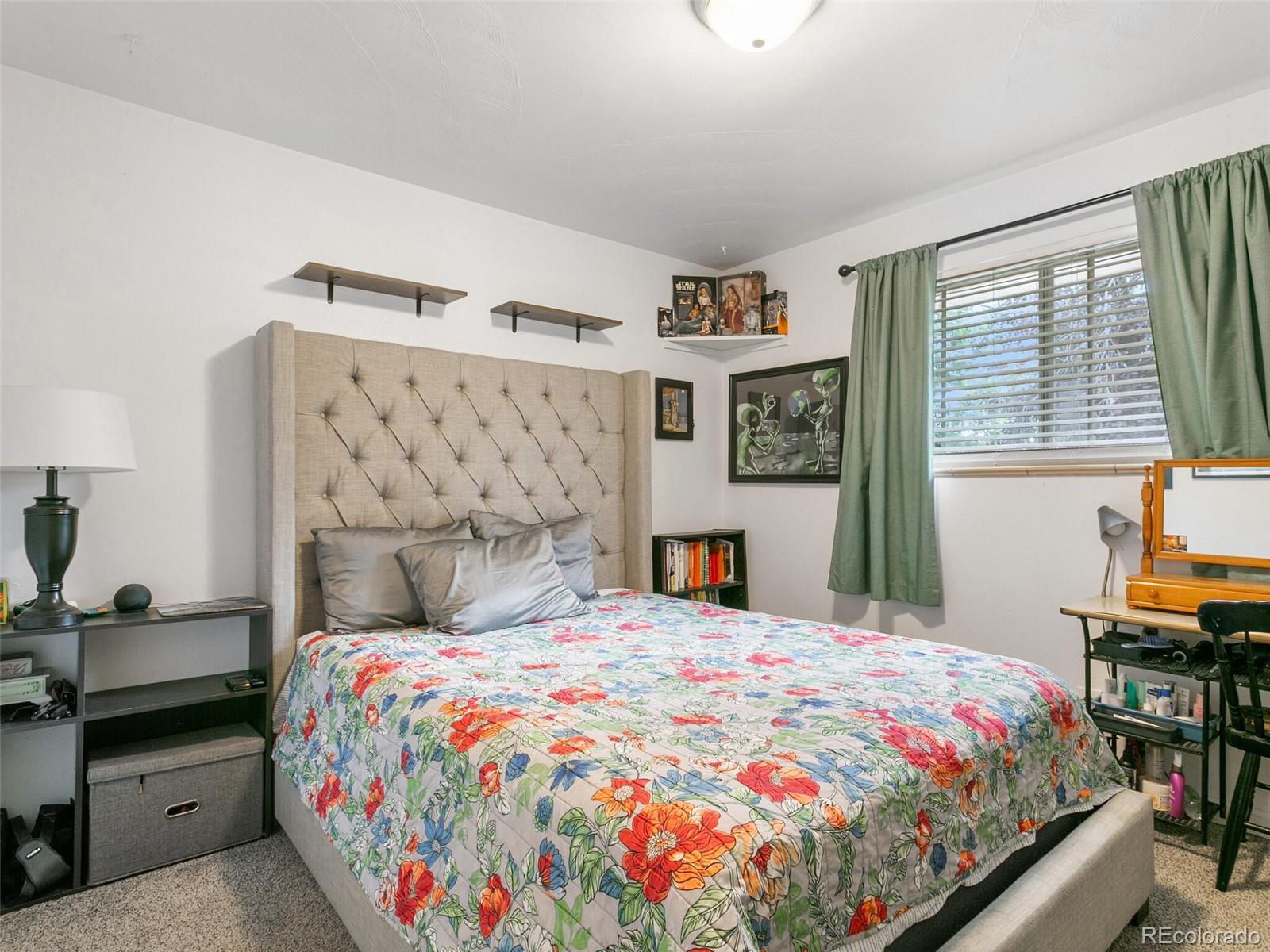 4615 Field Street Wheat Ridge, CO 80033 - Photo 13 of 39 a bedroom with a bed and a table in it