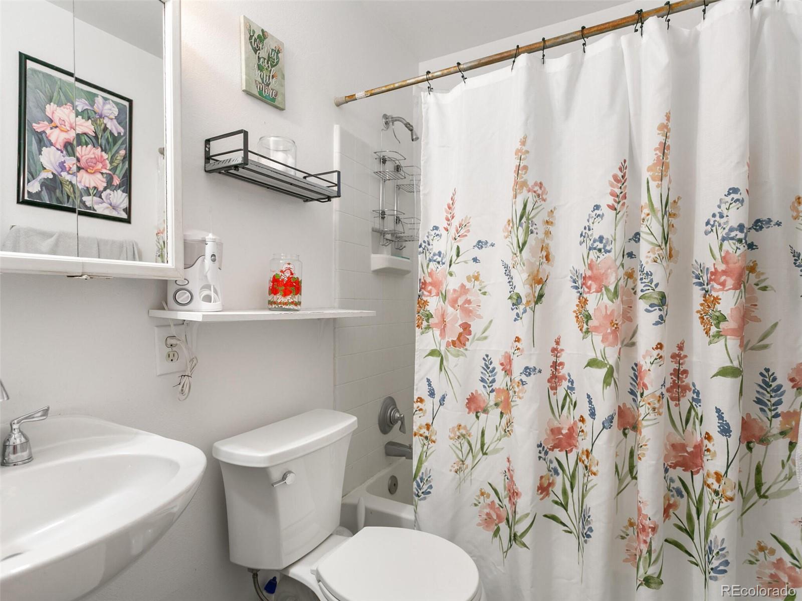 4615 Field Street Wheat Ridge, CO 80033 - Photo 15 of 39 a white toilet sitting next to a bathroom sink