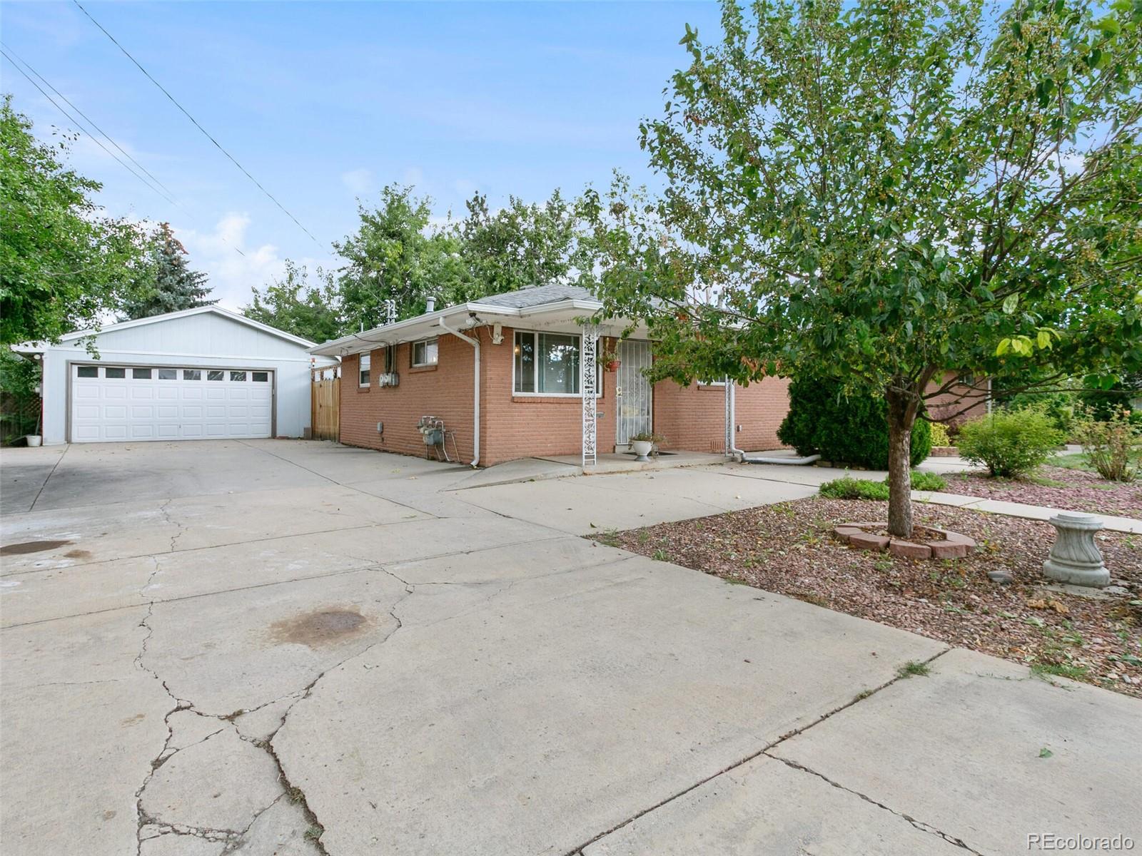 4615 Field Street Wheat Ridge, CO 80033 - Photo 20 of 39 a white house that has a tree in front of it