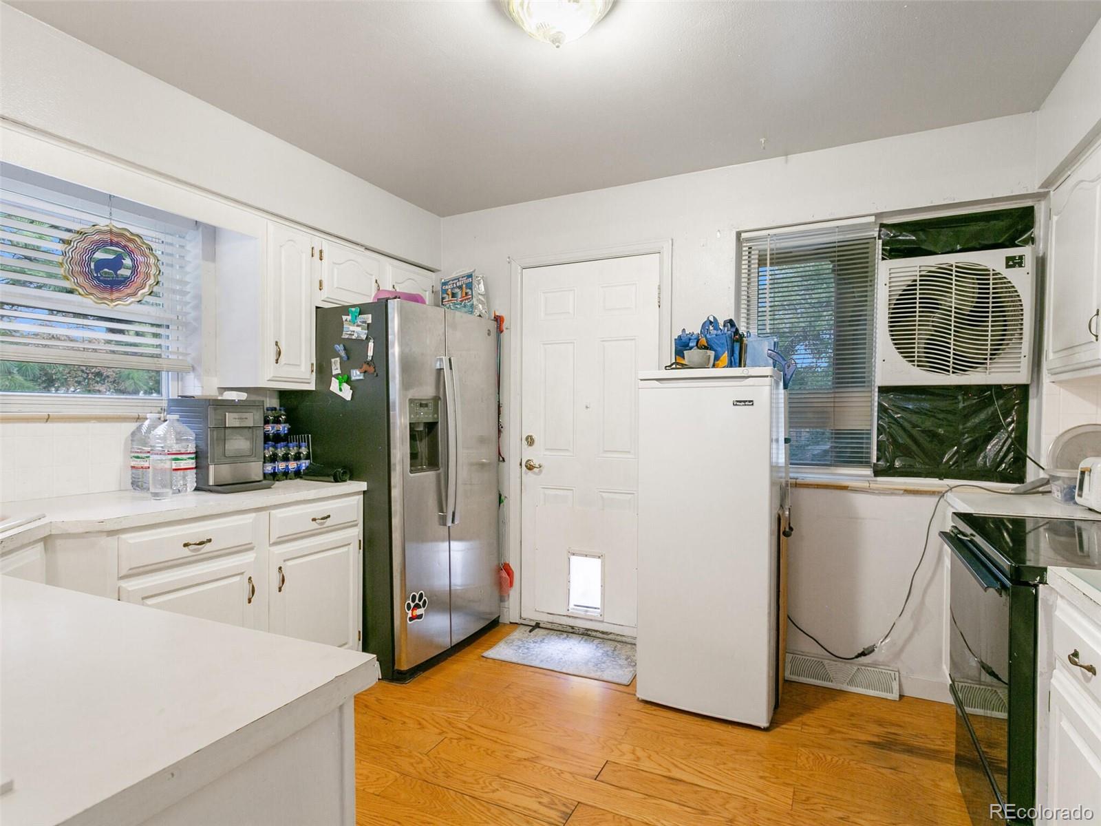 4615 Field Street Wheat Ridge, CO 80033 - Photo 24 of 39 a room with a refrigerator and a stove top oven