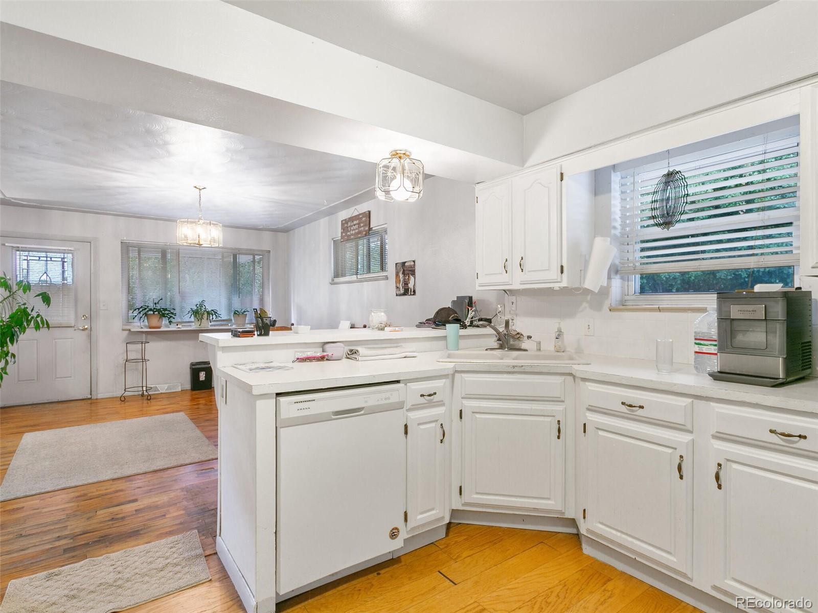 4615 Field Street Wheat Ridge, CO 80033 - Photo 25 of 39 a kitchen with a sink cabinets and window