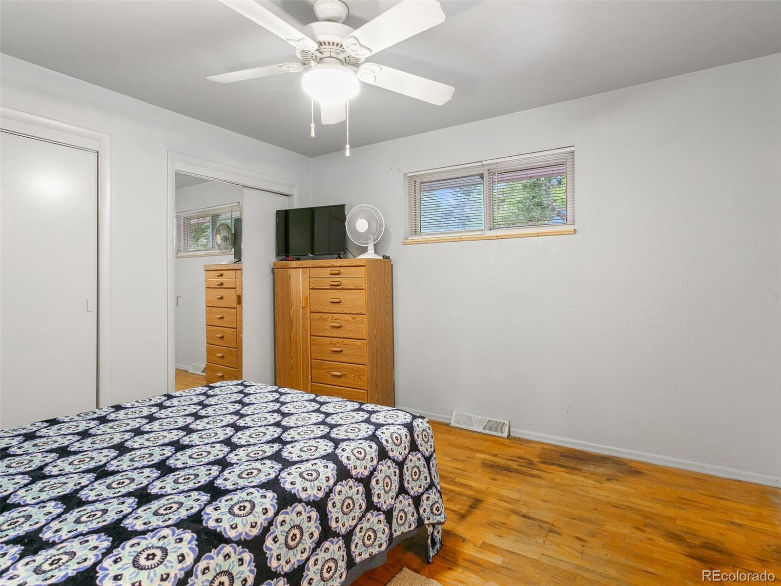 4615 Field Street Wheat Ridge, CO 80033 - Photo 30 of 39 a bedroom with a bed and a flat screen tv