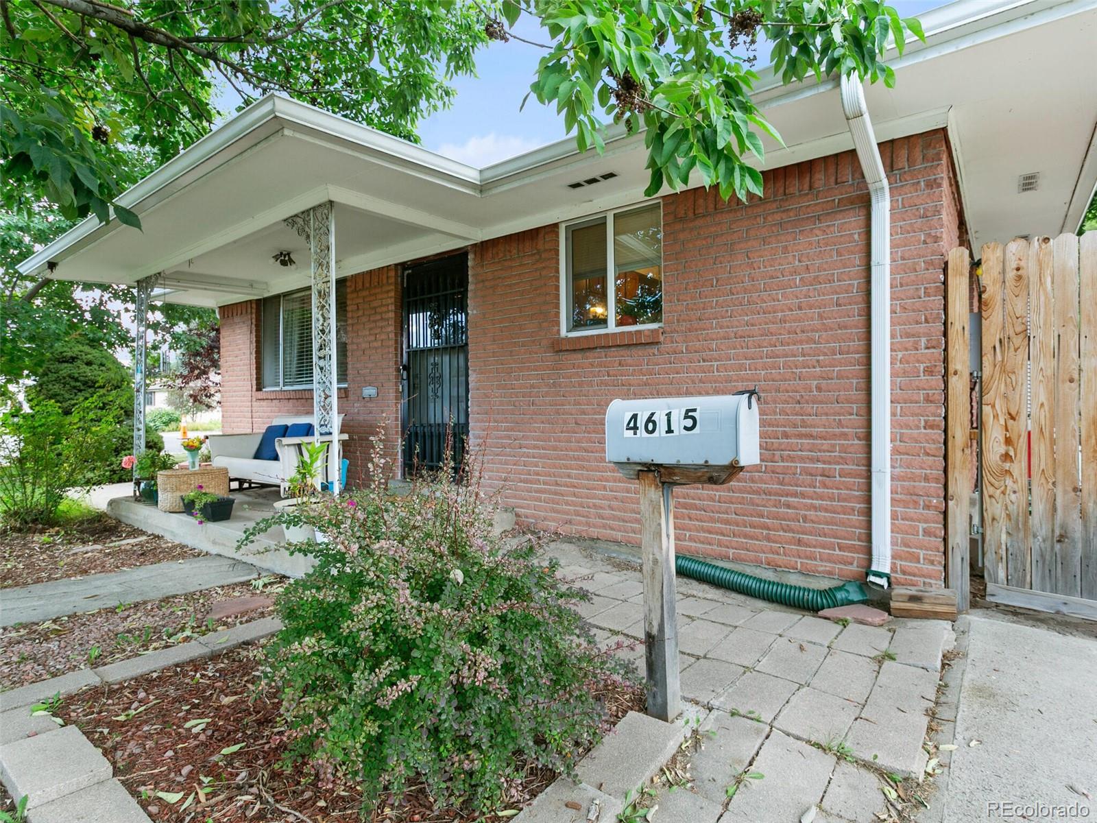 4615 Field Street Wheat Ridge, CO 80033 - Photo 3 of 39 a view of a brick house with large windows