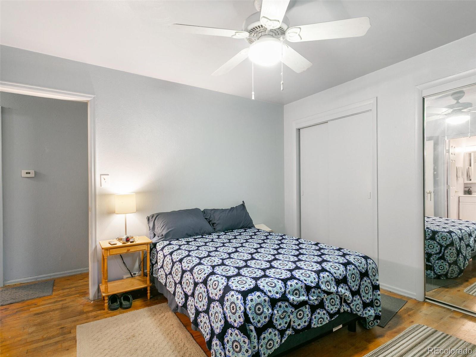 4615 Field Street Wheat Ridge, CO 80033 - Photo 31 of 39 a bedroom with a bed and a chandelier