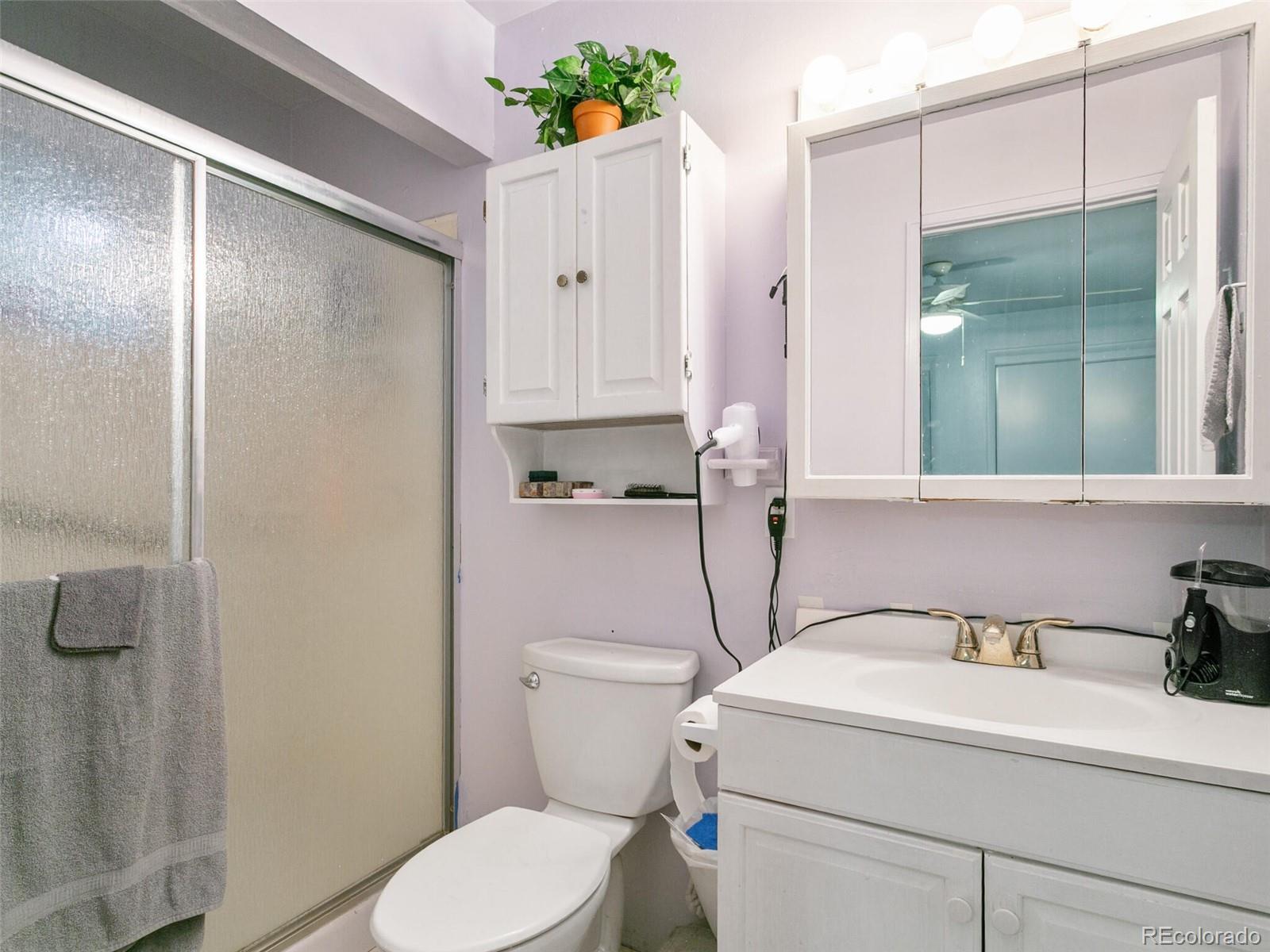 4615 Field Street Wheat Ridge, CO 80033 - Photo 32 of 39 a bathroom with a sink a toilet and shower
