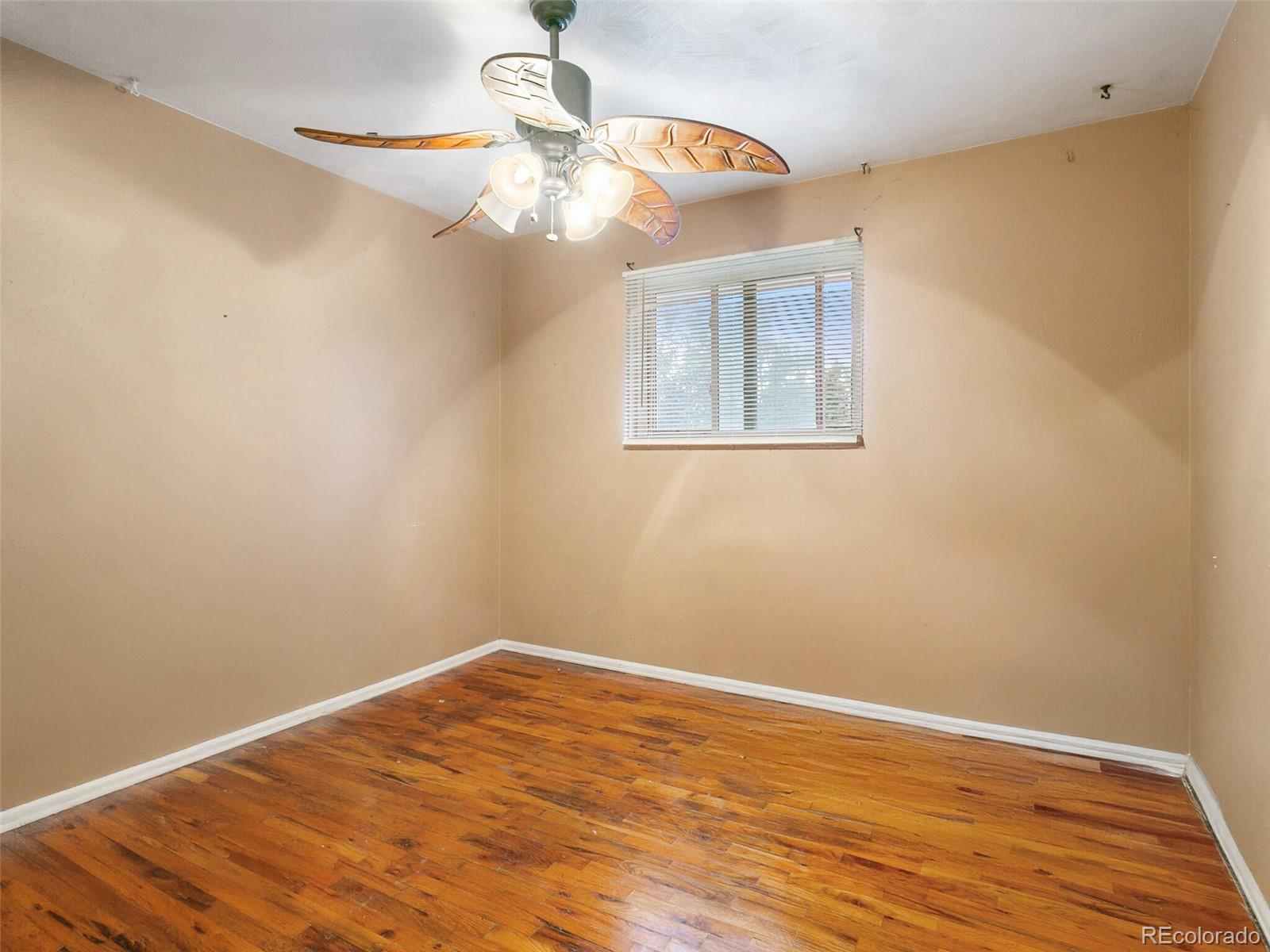 4615 Field Street Wheat Ridge, CO 80033 - Photo 33 of 39 a view of a room with wooden floor and chandelier