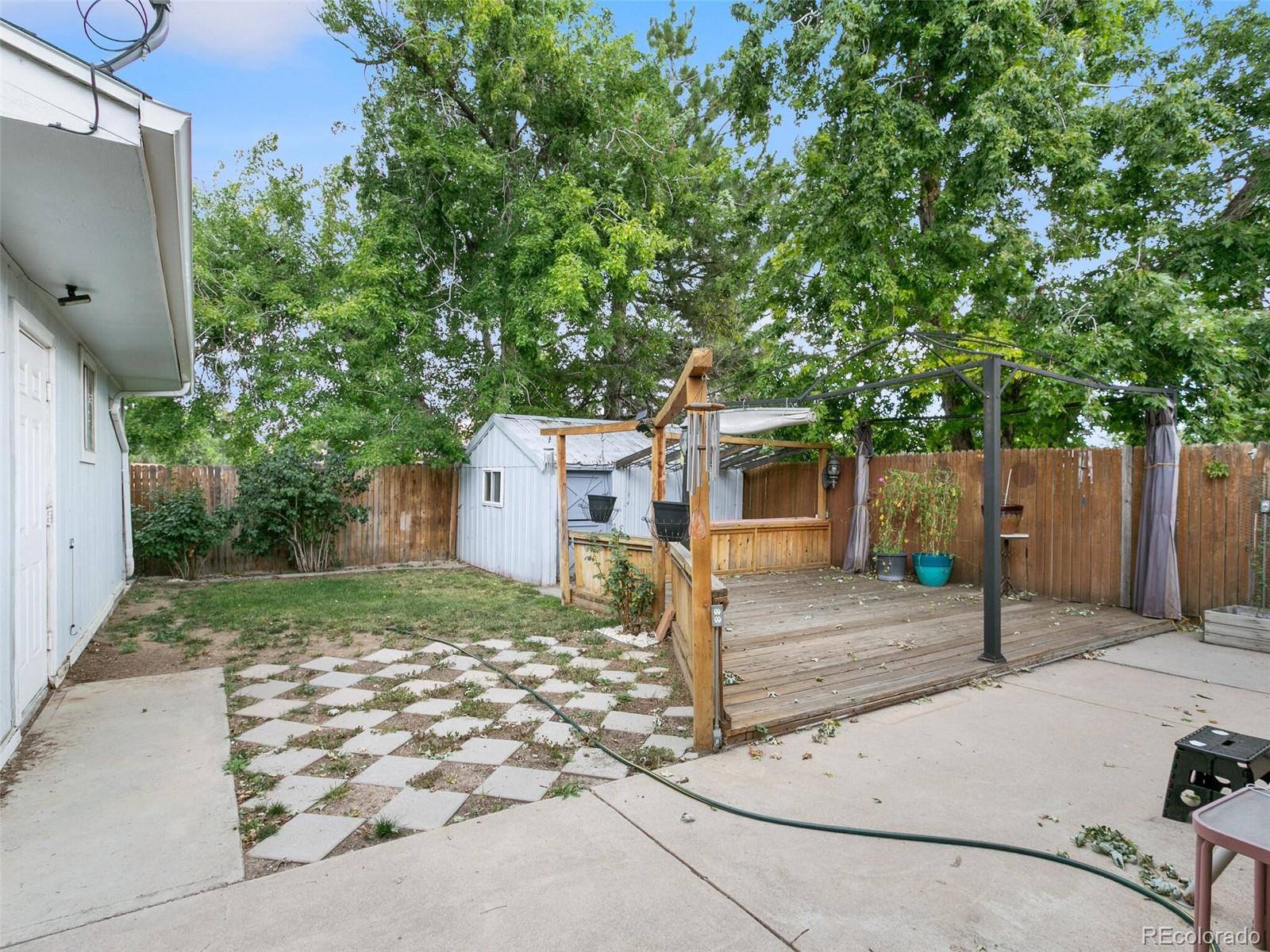 4615 Field Street Wheat Ridge, CO 80033 - Photo 35 of 39 a front view of a house with a yard and garage