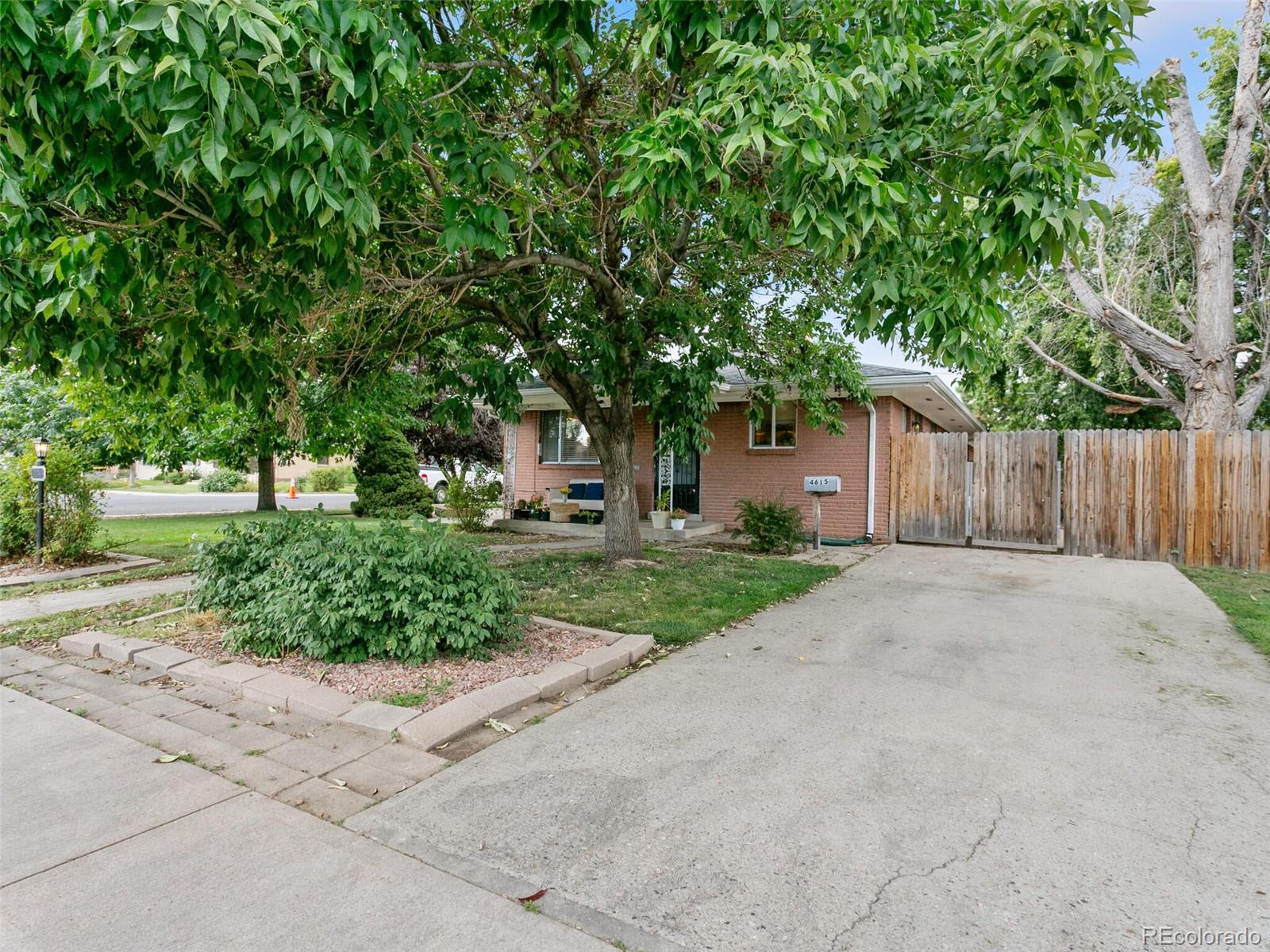 4615 Field Street Wheat Ridge, CO 80033 - Photo 4 of 39 a front view of a house with a yard and a garage