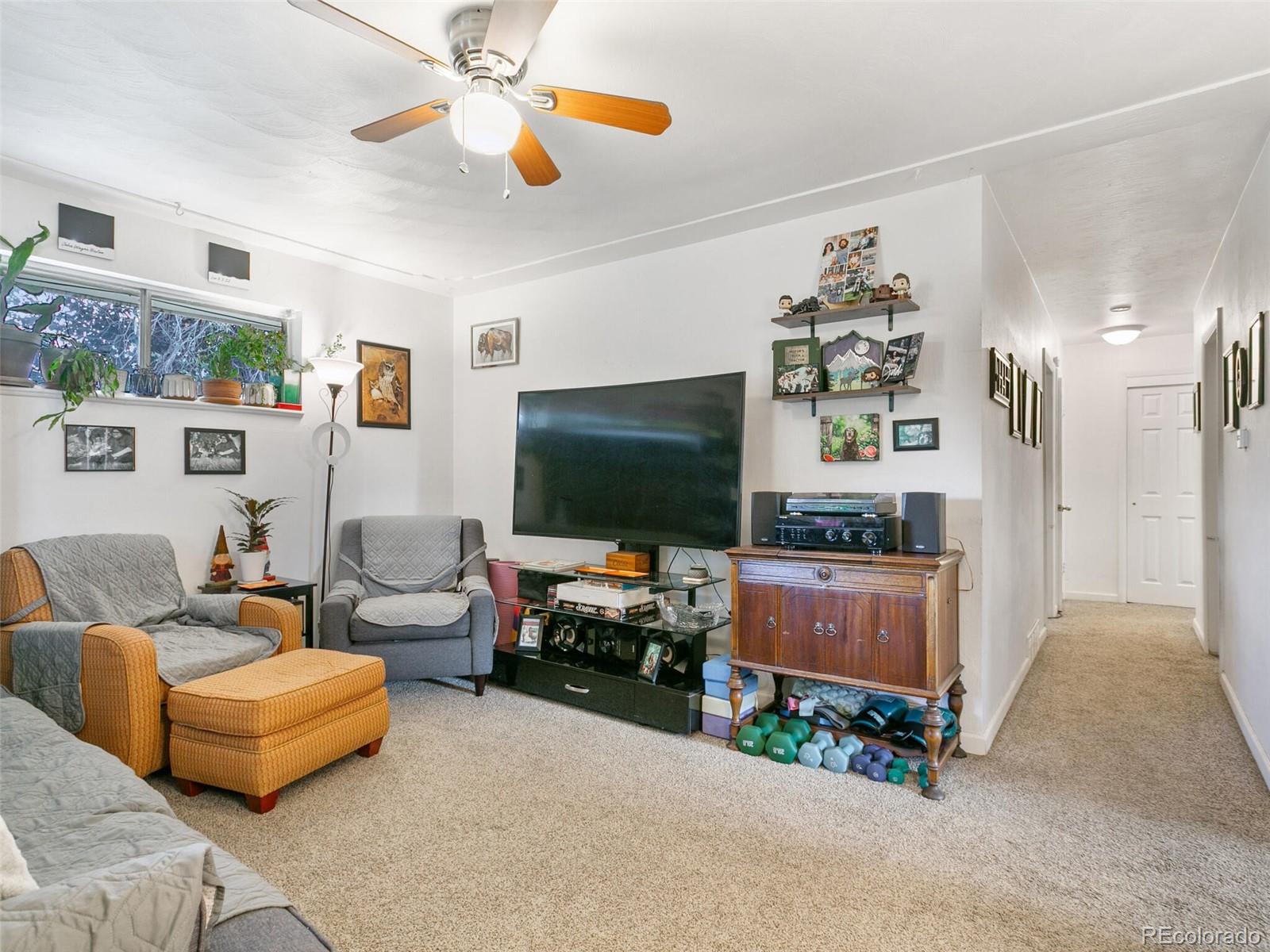 4615 Field Street Wheat Ridge, CO 80033 - Photo 6 of 39 a living room with furniture and a flat screen tv