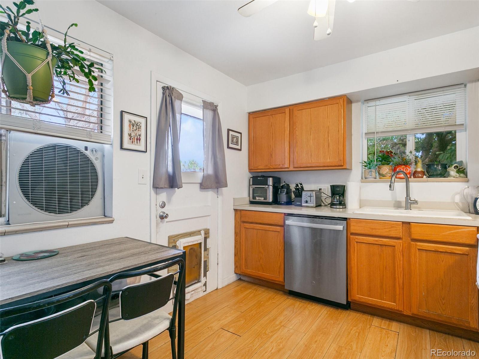 4615 Field Street Wheat Ridge, CO 80033 - Photo 9 of 39 a kitchen with stainless steel appliances granite countertop sink stove top oven and cabinets
