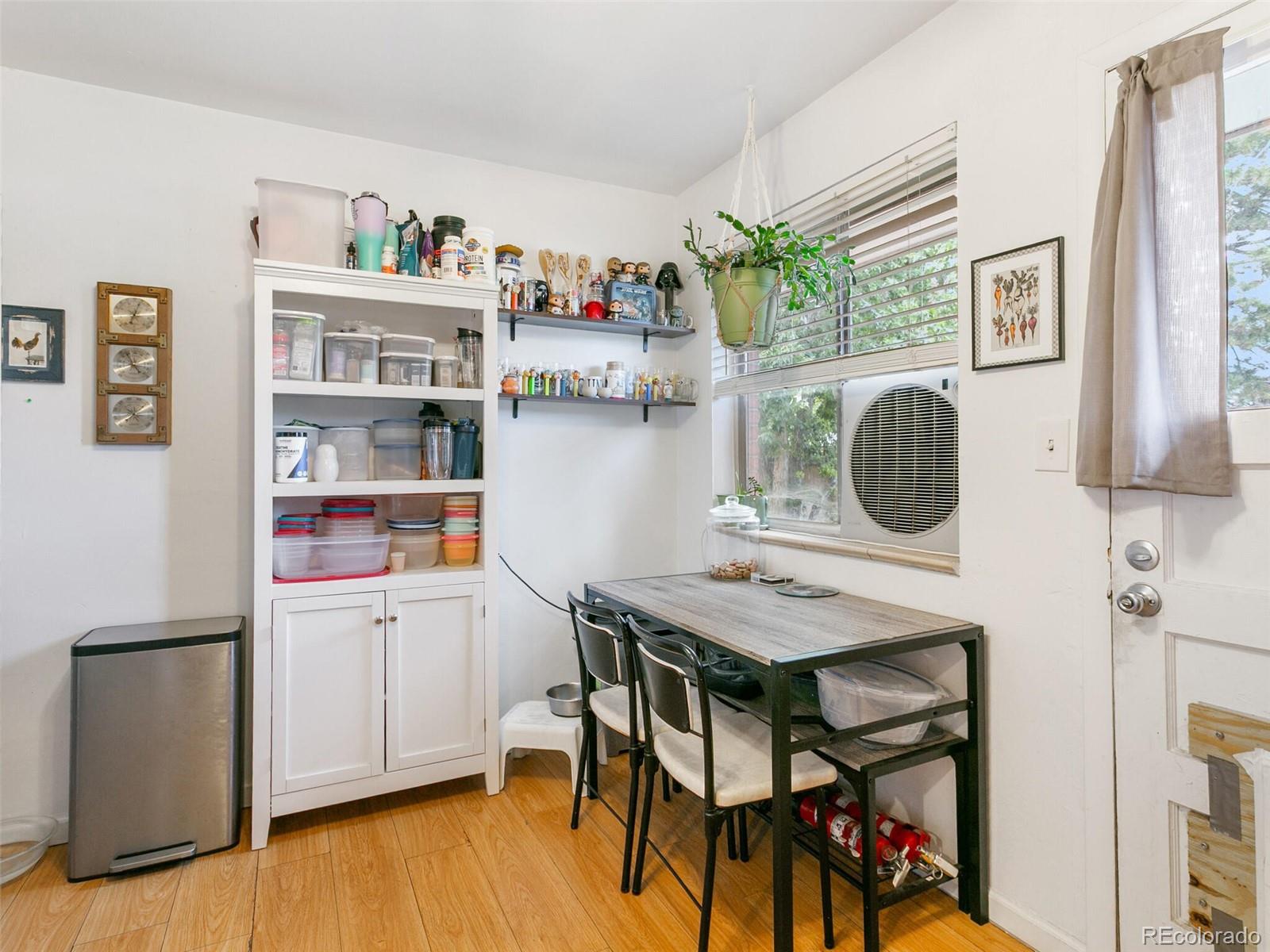 4615 Field Street Wheat Ridge, CO 80033 - Photo 10 of 39 a view of a dining room with furniture and wooden floor