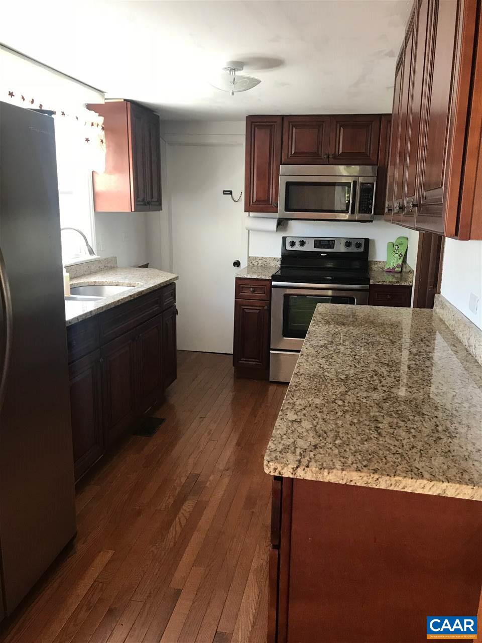 5596 Three Notch'd Road Crozet, VA 22932 - Photo 3 of 11 a kitchen with stainless steel appliances kitchen island granite countertop a refrigerator a stove top oven a sink and dishwasher