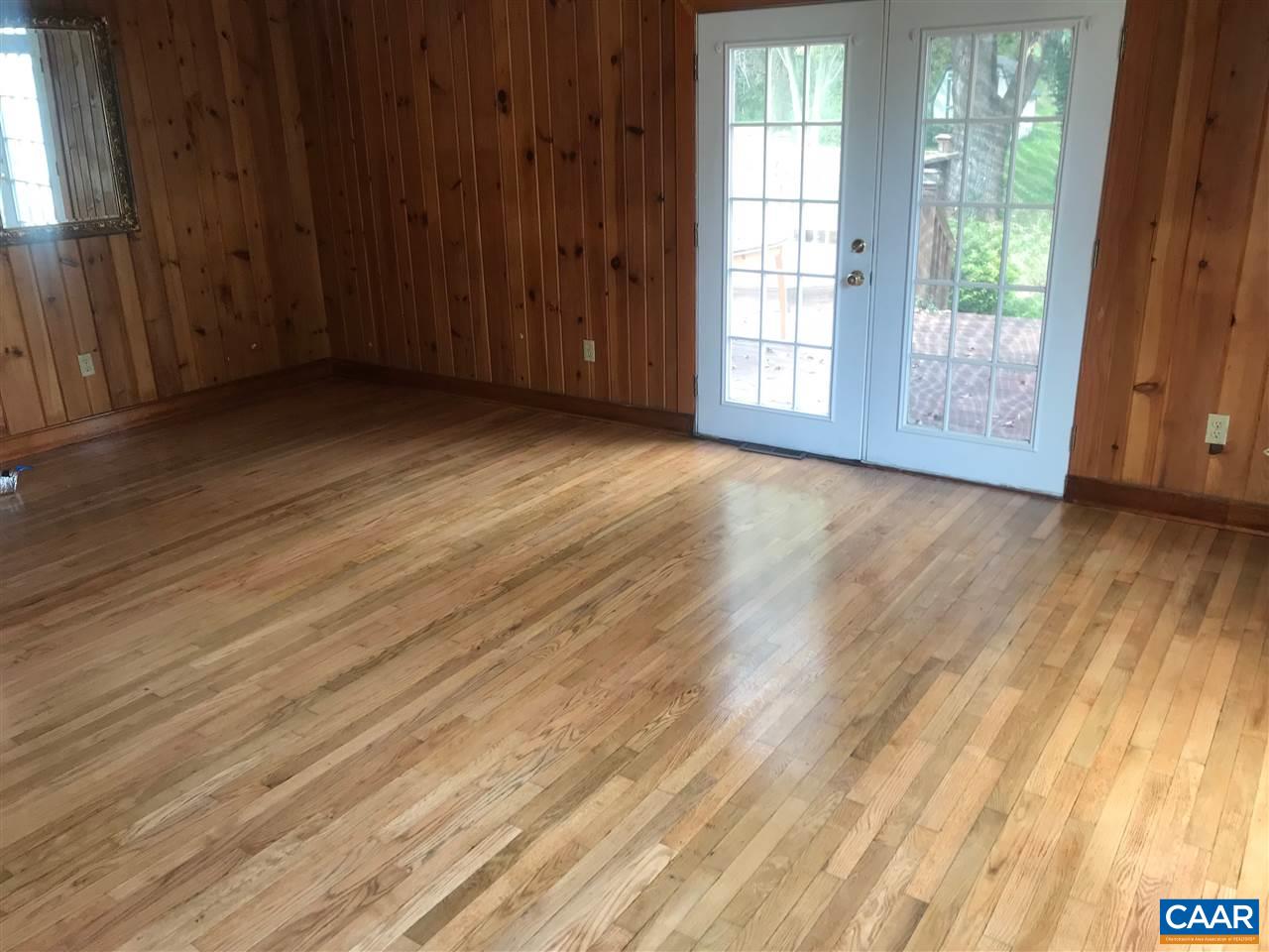 5596 Three Notch'd Road Crozet, VA 22932 - Photo 5 of 11 an empty room with wooden floor and sliding door