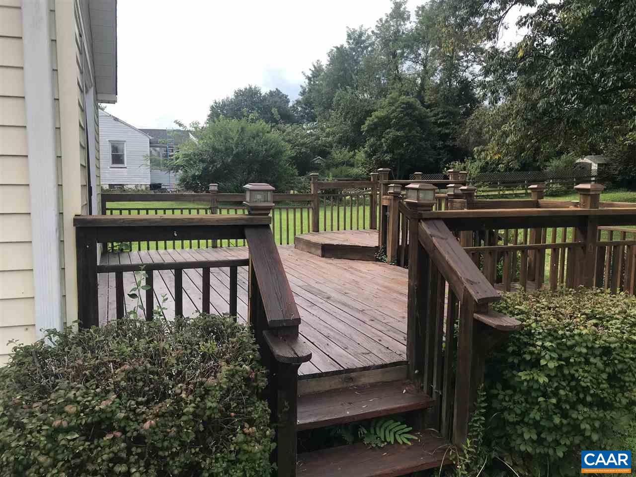 5596 Three Notch'd Road Crozet, VA 22932 - Photo 7 of 11 a view of a wooden deck with two chairs and a table