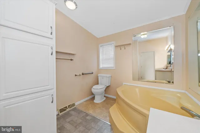 a bathroom with a granite countertop tub sink shower and mirror