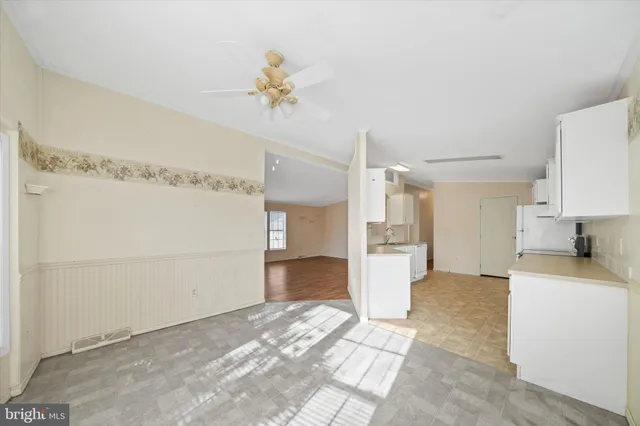 a view of a kitchen with a sink and a refrigerator