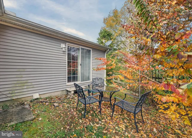 a porch with a bench and chairs