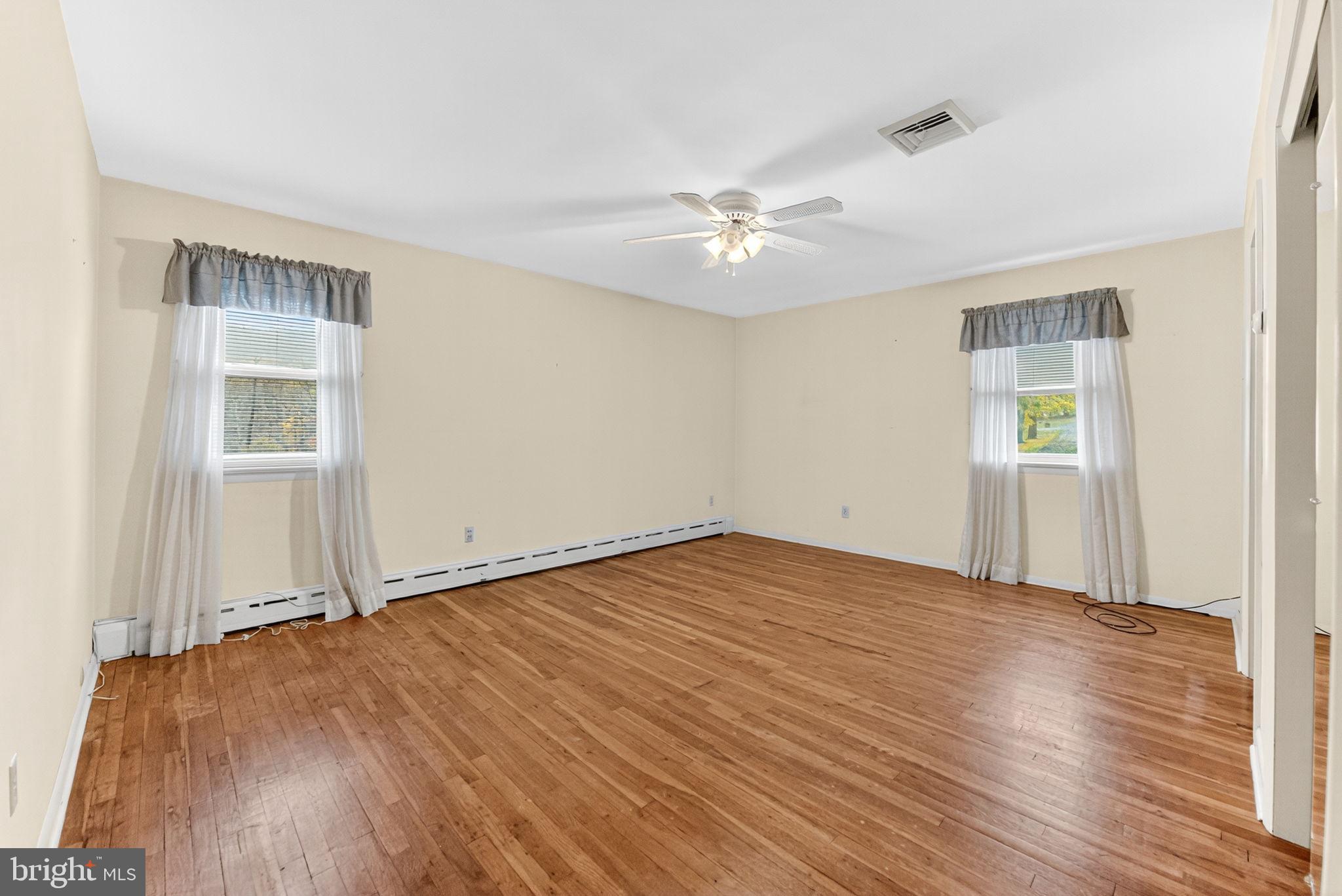 2304 Black River Road Bethlehem, PA 18015 - Photo 32 of 48 an empty room with wooden floor chandelier fan and windows