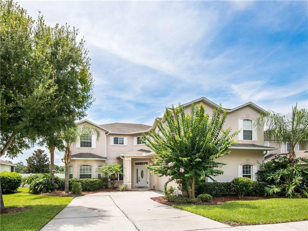 5228 Rishley Run Way Mount Dora, FL 32757 - Photo 1 of 1 a front view of a house with a yard and potted plants