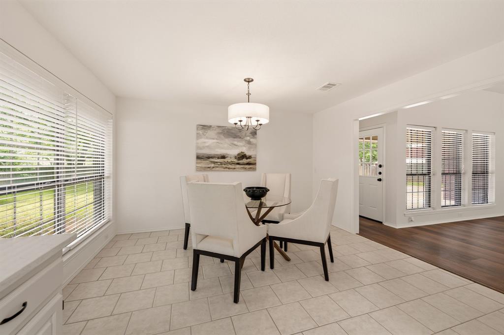 1805 Renfro Road Colleyville, TX 76034 - Photo 10 of 40 Bright interior space featuring light-colored rectangular tile flooring, a large window with horizontal blinds, and a built-in ceiling light fixture