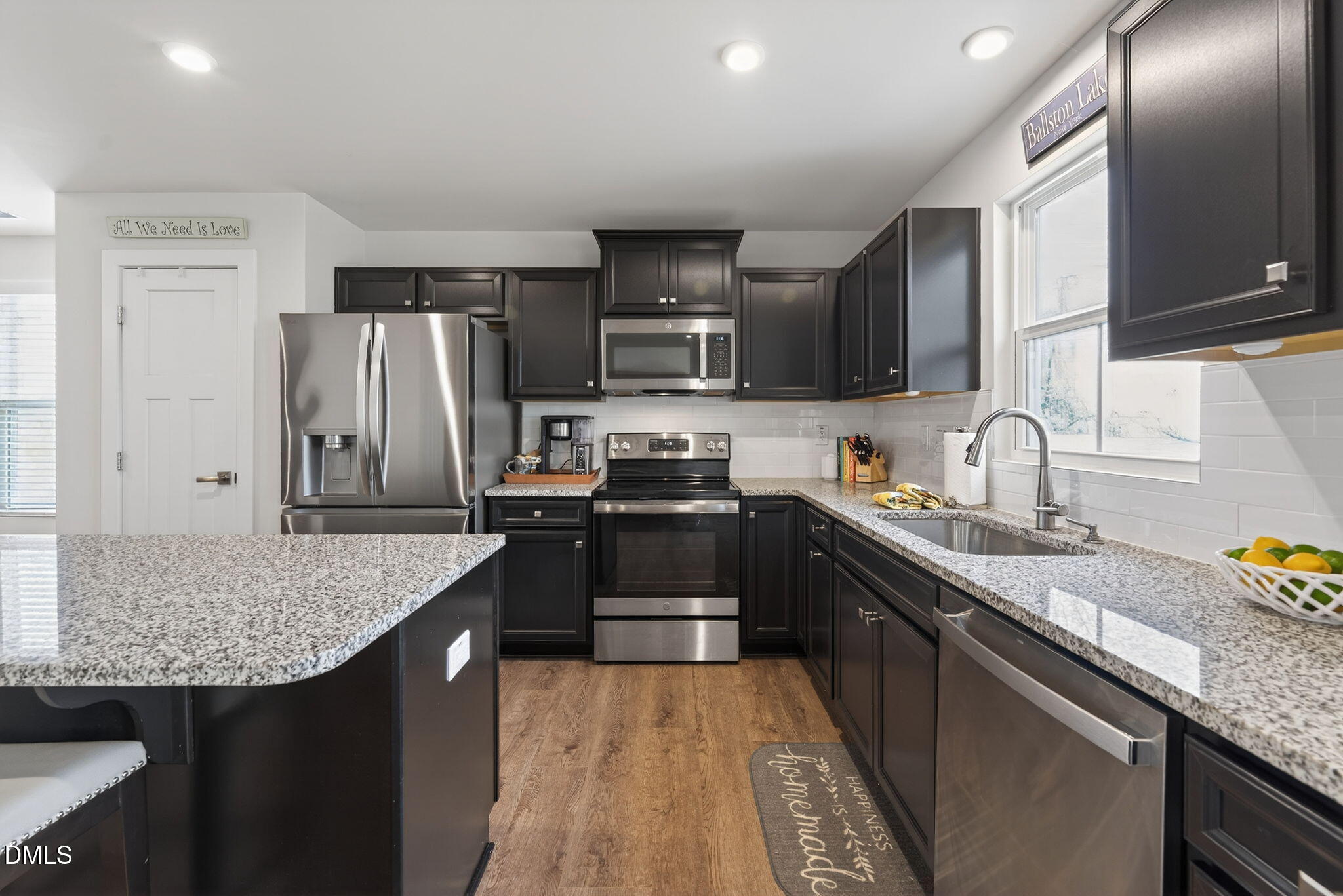 636 Jasmine Street Wendell, NC 27591 - Photo 13 of 30 a kitchen with stainless steel appliances granite countertop a sink stove and refrigerator