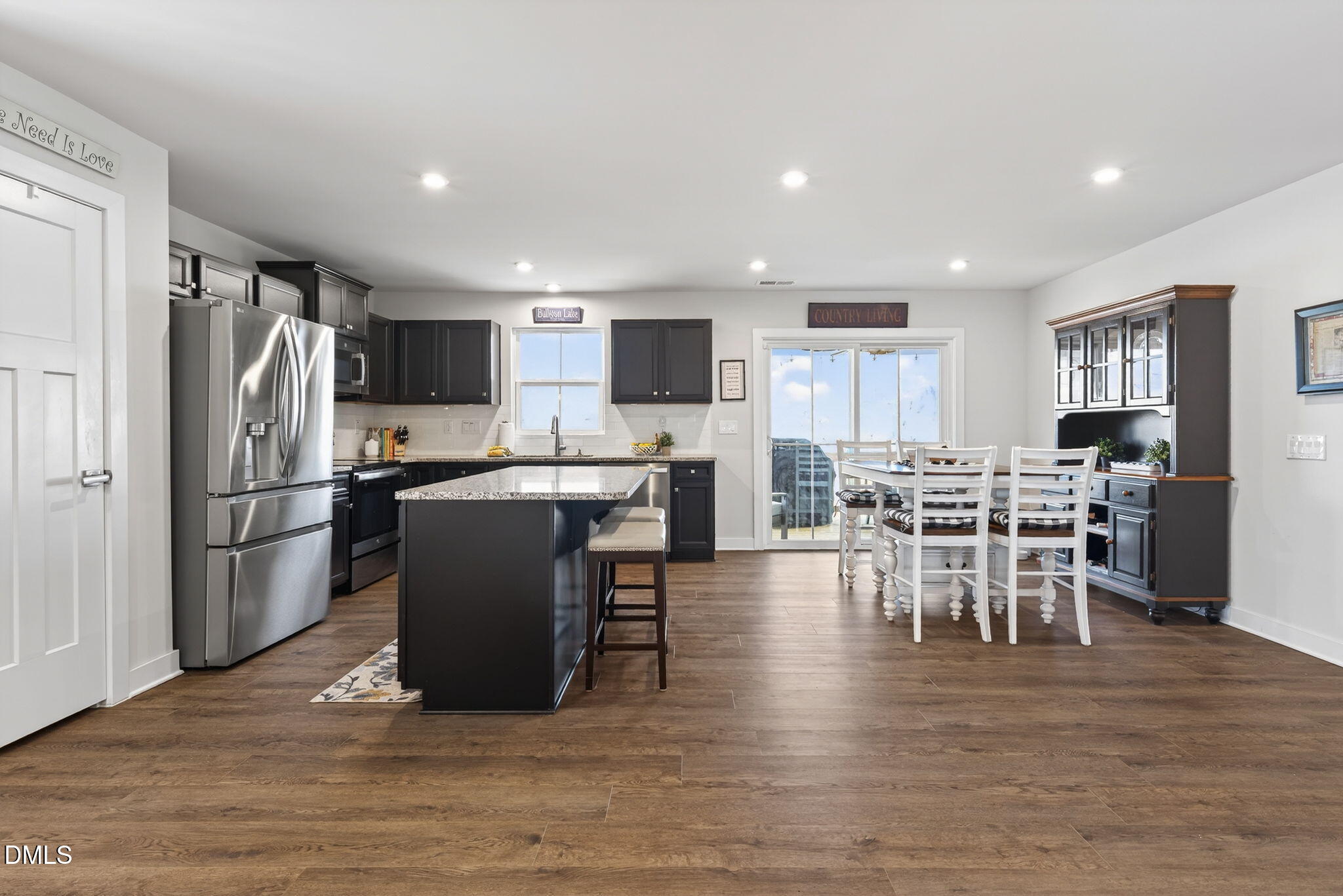 636 Jasmine Street Wendell, NC 27591 - Photo 8 of 30 a living room with stainless steel appliances furniture dining table and wooden floor