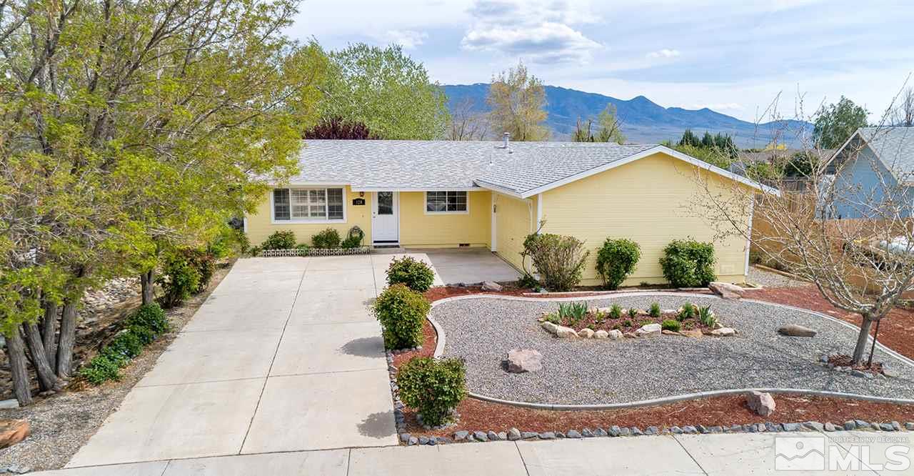 128 Empire Road Dayton, NV 89403 - Photo 1 of 20 a front view of a house with garden