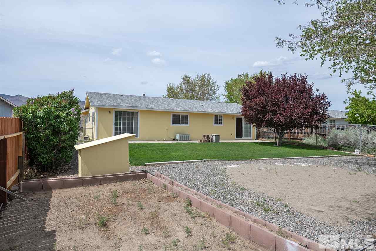 128 Empire Road Dayton, NV 89403 - Photo 4 of 20 a view of a house with a yard and large tree