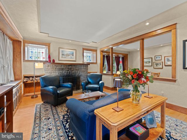 a living room with furniture a flat screen tv and a window