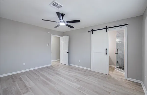 a view of an empty room and wooden floor