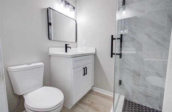 a white toilet sitting next to a bathroom sink