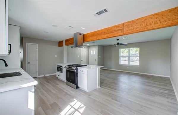a kitchen with a stove a sink and a refrigerator