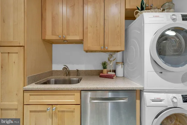 a kitchen with a sink and a washer dryer