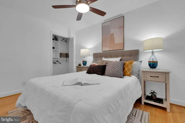 a bedroom with bed and a night stand