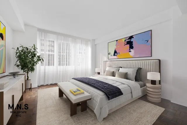 a bedroom with a bed and a potted plant