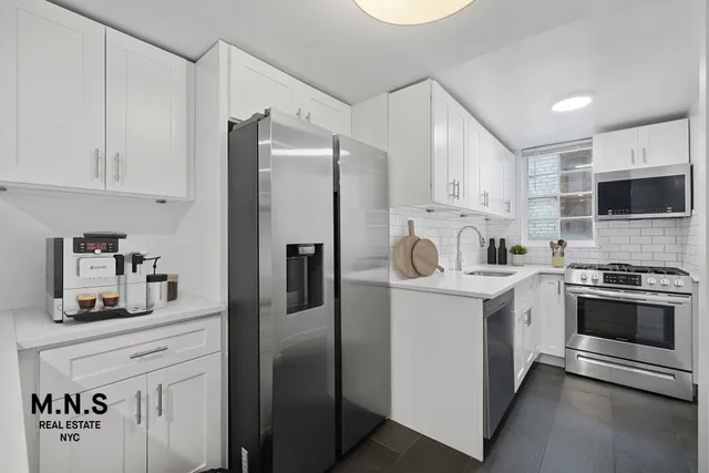 a kitchen with stainless steel appliances a refrigerator sink and microwave