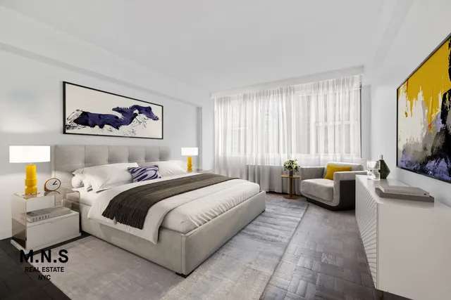 a bedroom with bed couch and window