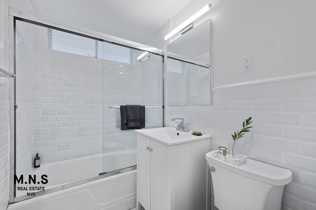 65 West 55th Street, Unit PHRE Manhattan, NY 10019 - Photo 10 of 12 a bathroom with a sink a toilet and shower