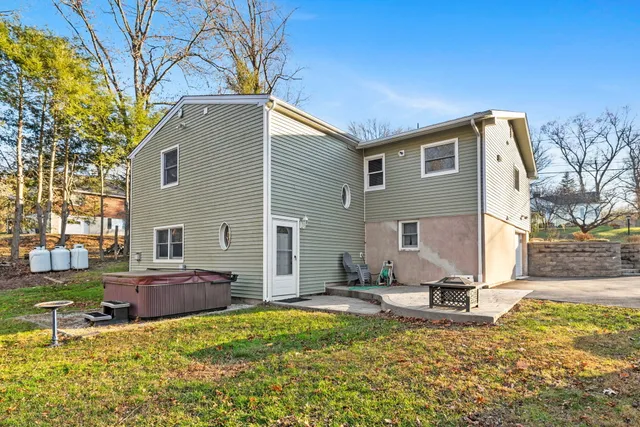 a backyard of a house with table and chairs