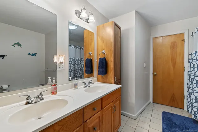 a bathroom with a double vanity sink and a mirror