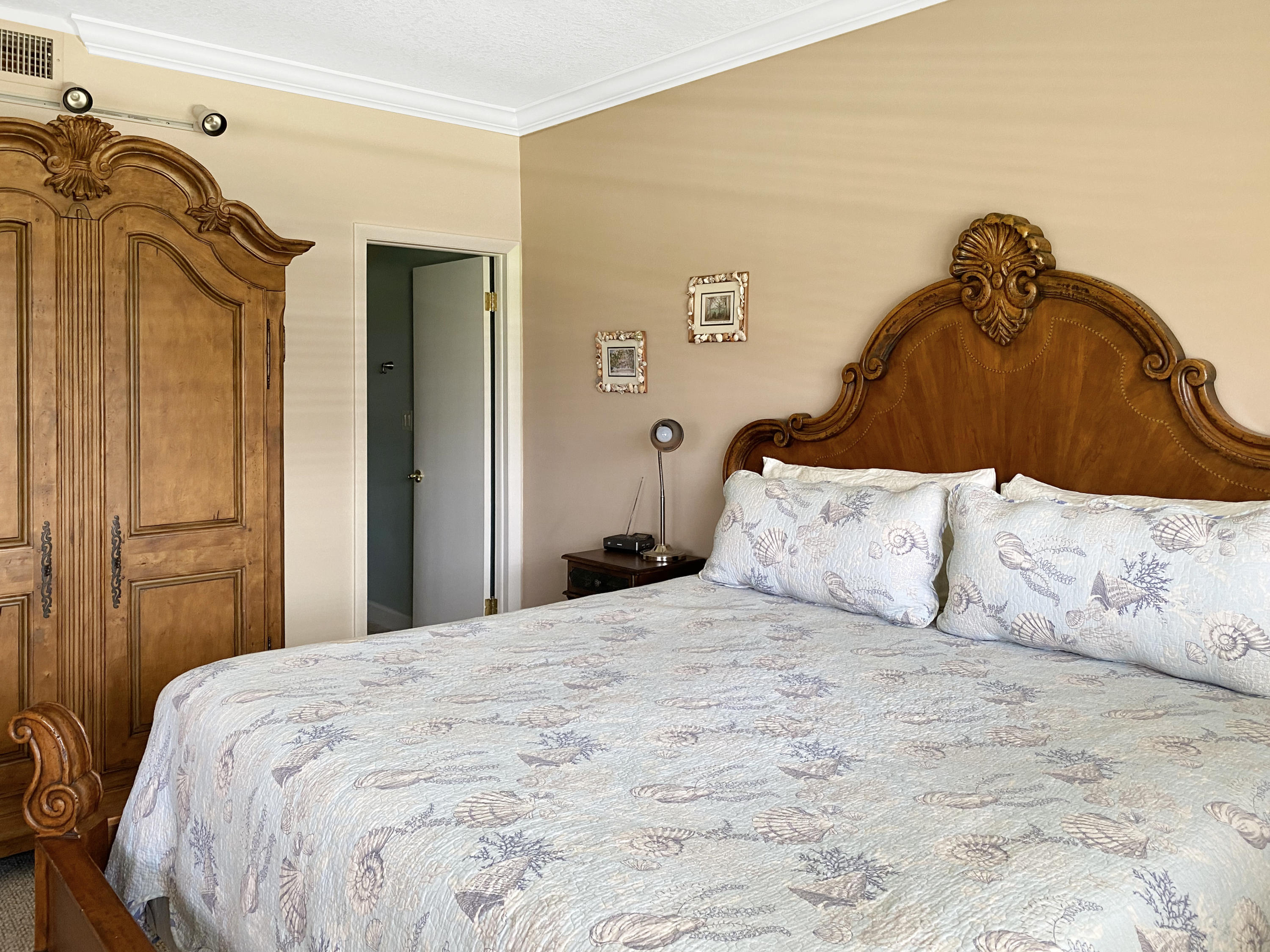 275 South Beach Road, Unit B202 Jupiter, FL 33469 - Photo 13 of 25 a bedroom with a bed and a walk in closet