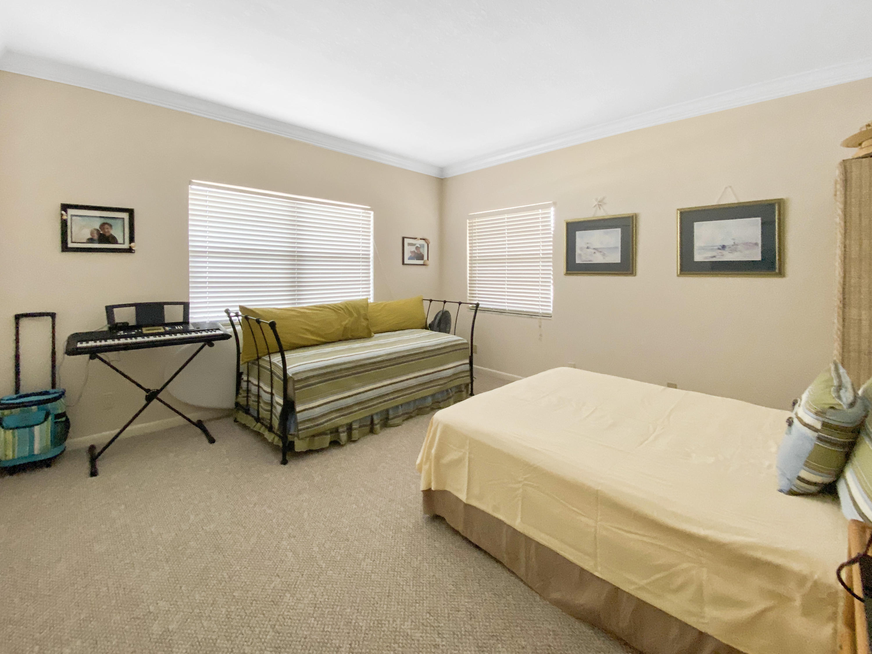 275 South Beach Road, Unit B202 Jupiter, FL 33469 - Photo 20 of 25 a bedroom with two beds and a couch