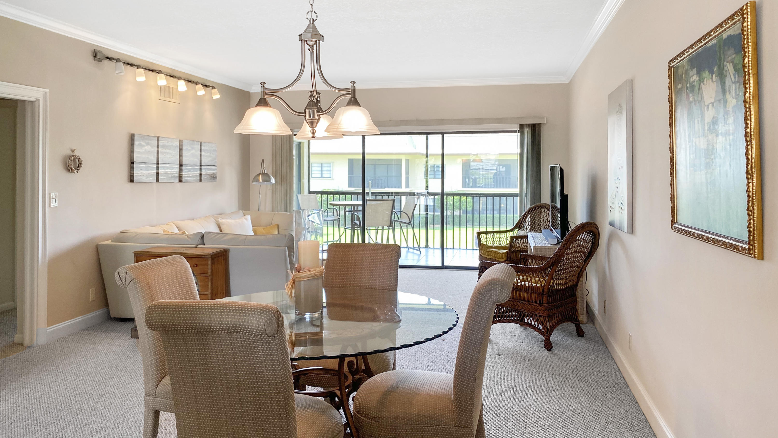 275 South Beach Road, Unit B202 Jupiter, FL 33469 - Photo 4 of 25 a dining room with furniture a chandelier and wooden floor