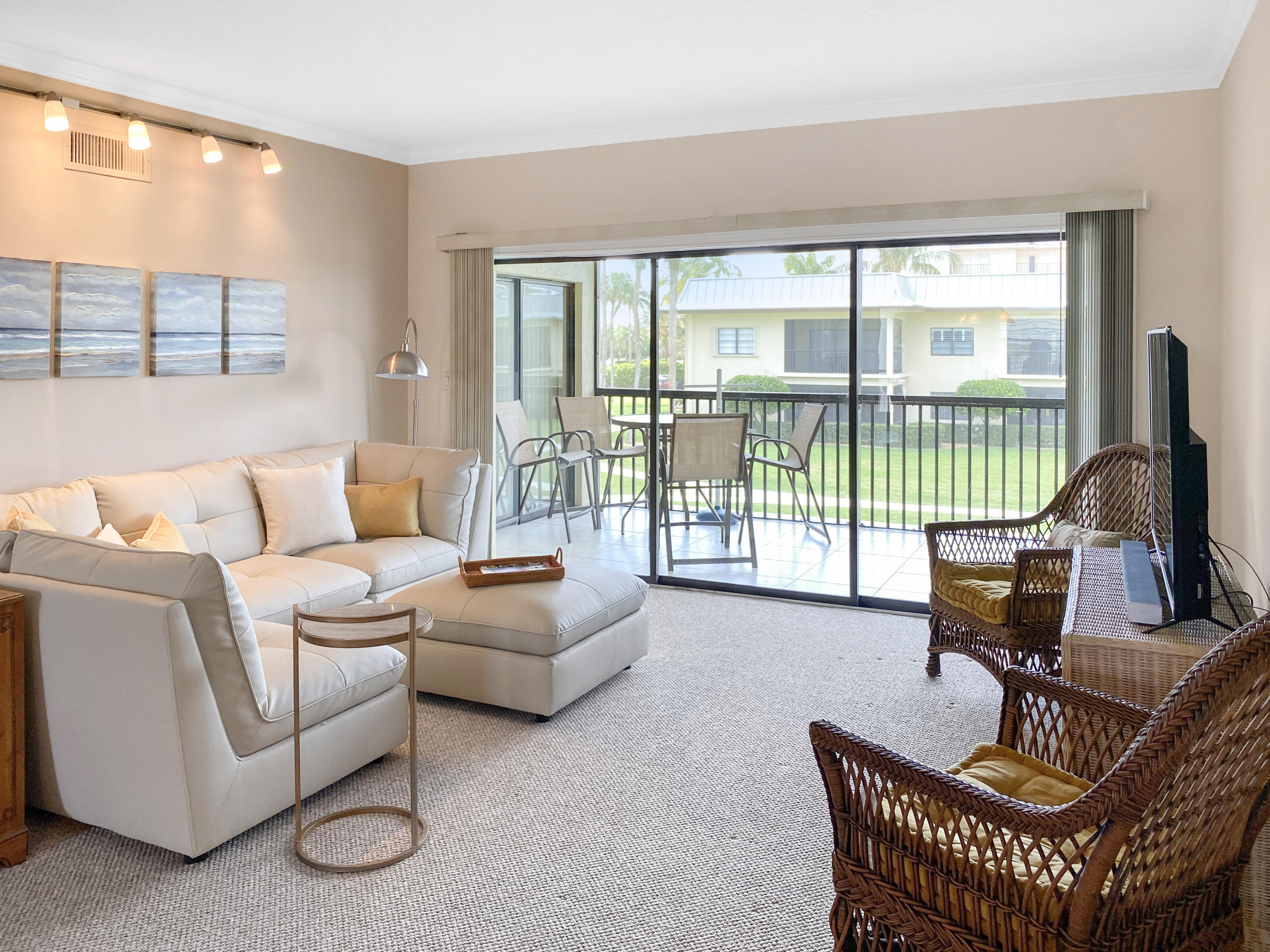 275 South Beach Road, Unit B202 Jupiter, FL 33469 - Photo 5 of 25 a living room with furniture and a floor to ceiling window