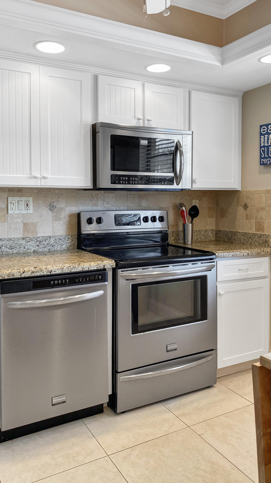 275 South Beach Road, Unit B202 Jupiter, FL 33469 - Photo 10 of 25 a kitchen with granite countertop a stove and a sink