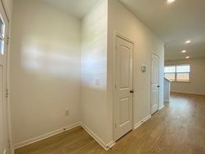 213 Saide Street Georgetown, TX 78626 - Photo 4 of 32 Entryway featuring wood-finish flooring, white baseboards, and a white paneled door