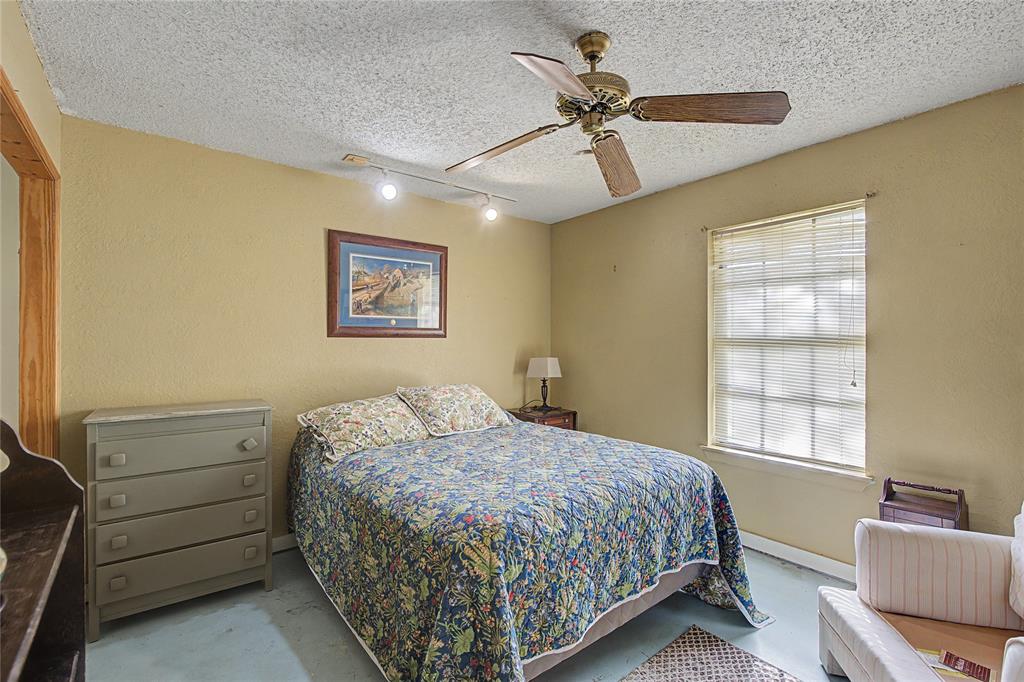 243 County Road 3851 Poolville, TX 76487 - Photo 20 of 34 a bedroom with a bed and furniture
