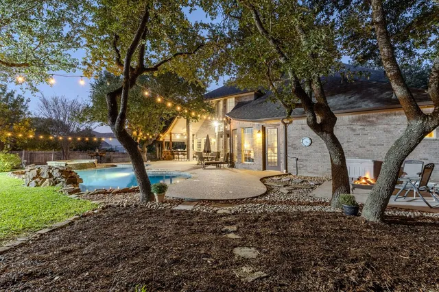 a view of a house with pool and sitting area