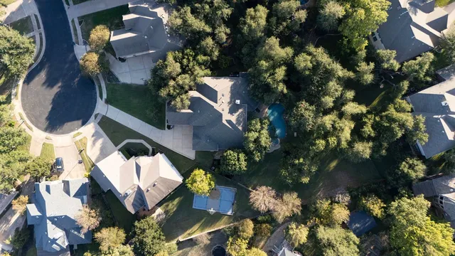 an aerial view of a house with yard