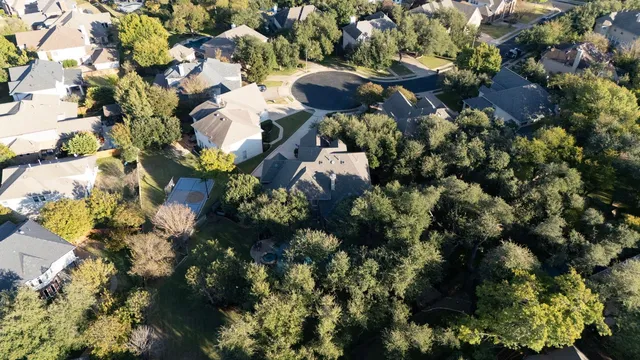 an aerial view of a house with a yard and garden